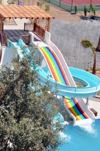 a water slide in a pool with a rainbow at Side Prenses Resort Hotel & Spa in Side