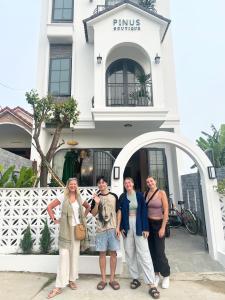 a group of people standing in front of a building at Hoi An Pinus Boutique in Tân Thành (1)