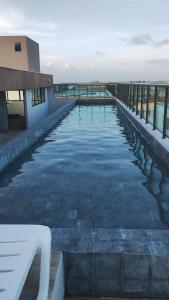 a pool of water in front of a building at STUDIO PORTO PRIME PREMIUM in Porto De Galinhas