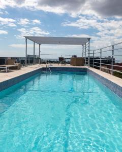a swimming pool on the roof of a building at Chateau Apartment in New Kingston