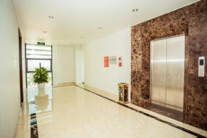 an empty lobby with a elevator and a potted plant at Royal ANAN Hotel in Ninh Binh