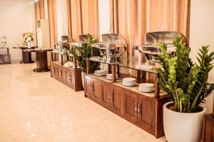 a buffet line with plates and dishes on display at Royal Hotel Ninh Bình in Ninh Binh