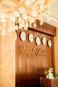 a row of clocks on a wall with the words royal hotel at Royal Hotel Ninh Bình in Ninh Binh