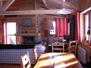 a living room with a wooden table and a fireplace at Chalet Vars, 6 pièces, 12 personnes - FR-1-773-13 in Vars