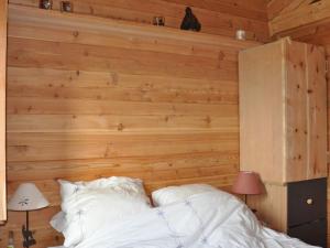 a bedroom with wooden walls and a bed with white pillows at Chalet Vars, 6 pièces, 12 personnes - FR-1-773-13 in Vars