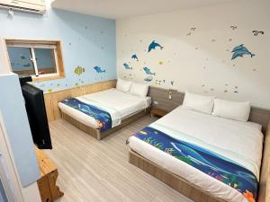 Postel nebo postele na pokoji v ubytování 安可的家 小孩及寵物免費 恆春老街夜市 屏東縣民宿0497