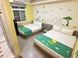 Postel nebo postele na pokoji v ubytování 安可的家 小孩及寵物免費 恆春老街夜市 屏東縣民宿0497