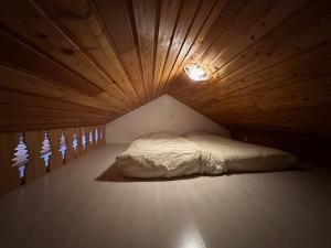 a bed in a room with a wooden ceiling at Appartement Vars, 2 pièces, 6 personnes - FR-1-773-5 in Vars