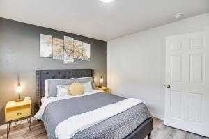 a bedroom with a bed and two paintings on the wall at Grand Junction Vacation Rental Near University! in Grand Junction