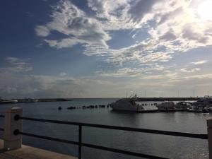 a boat docked in a harbor with a cloudy sky at Annette Rooms in Bari