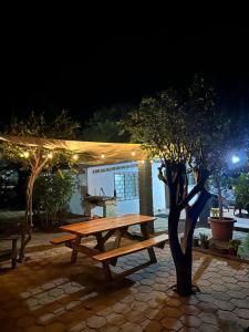 a picnic table in front of a pavilion at night at Surf City Town House in La Libertad