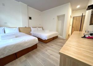 Postel nebo postele na pokoji v ubytování Yan Bin Hotel
