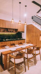 a dining room with a wooden table and chairs at Budha Manis Villa in Kerobokan