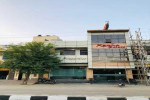 a building with writing on the side of it at OYO Hotel Kanha Palace in Kota