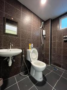 a bathroom with a toilet and a sink at Level 4 Simfoni Beliza in Kuah