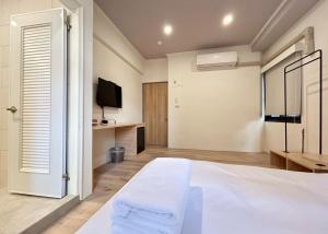 Postel nebo postele na pokoji v ubytování Yan Bin Hotel