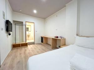 Postel nebo postele na pokoji v ubytování Yan Bin Hotel