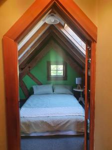 a bed in a room with an attic at Streamside Country Manor in Walton
