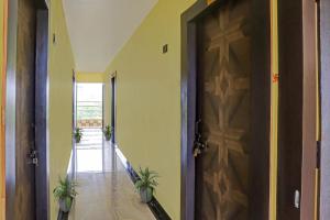 korytarz z drzwiami i dwoma doniczkami w obiekcie Flagship Hotel Jnk w mieście Bilaspur