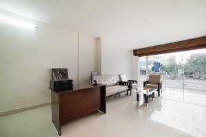 Karīmnagar的住宿－Collection O Hotel Aria Inn，客厅配有沙发和桌子