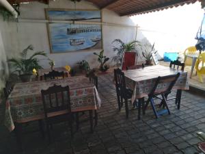 a dining room with a table and some chairs at Pousada Pôr do Sol - Galinhos in Galinhos