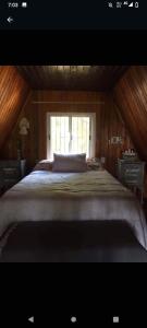 a large bed in a room with a window at La alpina playa nebel in Concordia