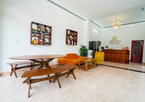 a living room with a table and chairs at The Sun Long Hai Hotel in Long Hai