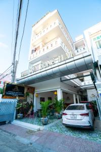 a car parked in front of a building at The Sun Long Hai Hotel in Long Hai