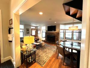 a dining room and living room with a dining table at The Residence on South Oak - steps to the gondola! in Telluride