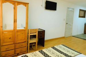 1 dormitorio con tocador y escritorio con espejo en Suit Privada, en El Tambo