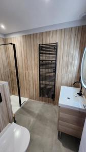 a bathroom with a sink and a toilet and a mirror at Villa Ty Spa in Plouhinec +7 photos
