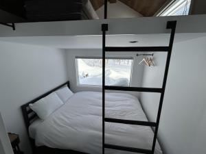 a bunk bed in a small room with a window at EL CAMINO Makkari in Makkari