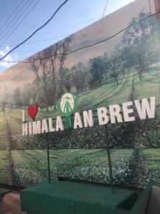 a sign that says imla an brew in a window at Rana's House, Mcleodganj in McLeod Ganj