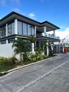 a large house with a road in front of it at Villa Tobias San Juan Batangas in Batangas City