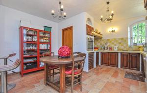a kitchen with a table and a dining room at 1 Bedroom Stunning Apartment In Grasse in Grasse