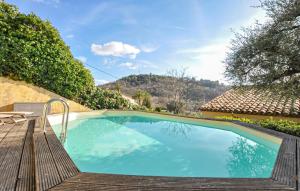 a swimming pool with a wooden deck and a house at 1 Bedroom Stunning Apartment In Grasse in Grasse +14 photos