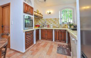 a kitchen with wooden cabinets and a window at 1 Bedroom Stunning Apartment In Grasse in Grasse