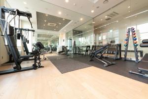 a gym with treadmills and ellipticals in a building at ON City Hotel in Cheonan