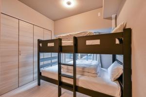 a bunk bed room with two bunk beds at MP Hotel Hakata in Fukuoka