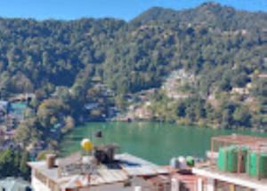 a view of a large lake in a city at Hotel H. K. Legacy Nainital in Nainital