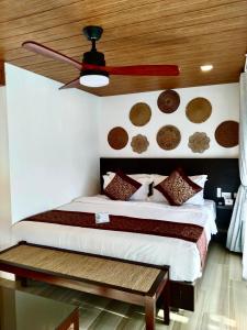 a bedroom with a bed and a ceiling at Commander Suites de Bohol in Panglao Island