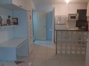 eine Küche mit weißen Schränken und einem weißen Kühlschrank in der Unterkunft Apartamento in Rio de Janeiro