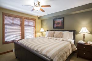 a bedroom with a bed and a ceiling fan at 1310 - One Bedroom Den Standard Eagle Springs West condo in Solitude