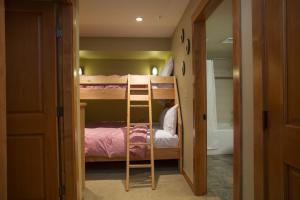 a bunk bed room with two bunk beds and a ladder at 1310 - One Bedroom Den Standard Eagle Springs West condo in Solitude