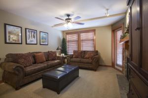 a living room with two couches and a ceiling fan at 1310 - One Bedroom Den Standard Eagle Springs West condo in Solitude