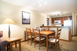 a kitchen and dining room with a table and chairs at 3406 - One Bedroom Den Standard Powderhorn Lodge condo in Solitude