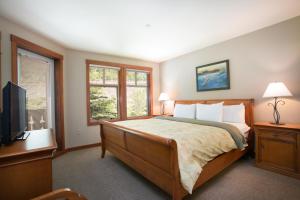 a bedroom with a large bed and a television at 2312 - Two Bedroom Den Standard Eagle Springs East condo in Solitude +7 photos