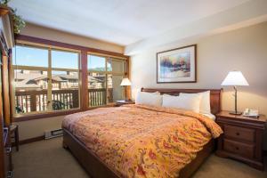 a bedroom with a bed and a large window at 3313 - One Bedroom Den Standard Powderhorn Lodge condo in Solitude