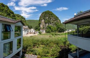 a view of the mountains from a house at Fanzhu Hotel in Xingyi