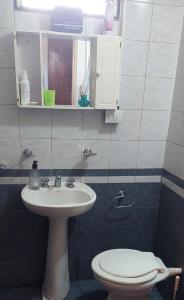 a bathroom with a sink and a toilet at La Casita de Marley in Villa Santa Cruz del Lago